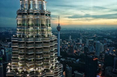 brown high rise buildings under blue sky at daytime malaysia teams background