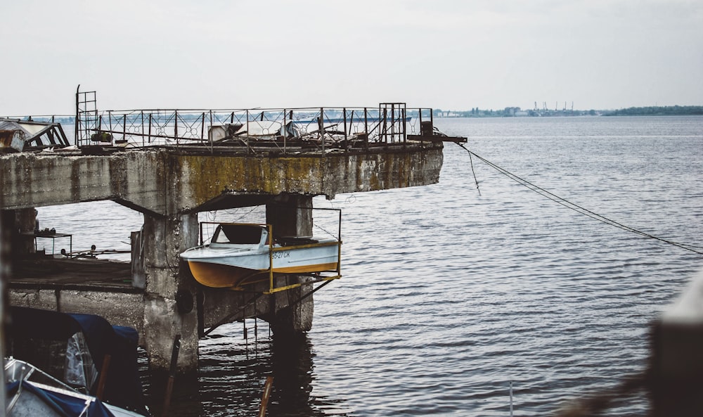 selective color of gray boat near body of water