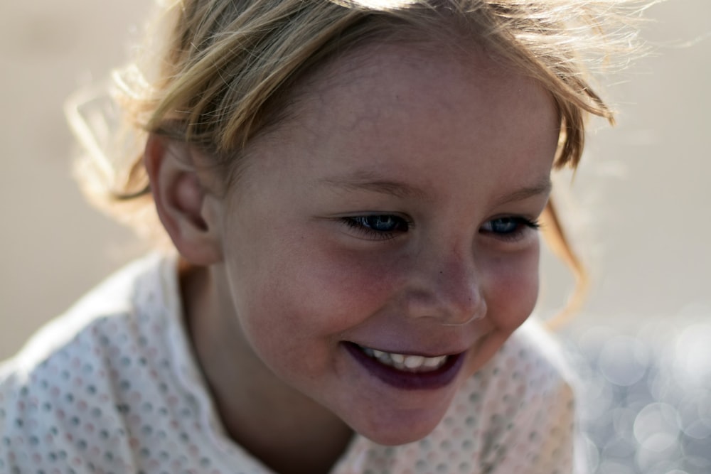 selective focus photo of young smiling girl