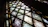 Close-up of a handcrafted stained glass panel glowing warmly in natural light