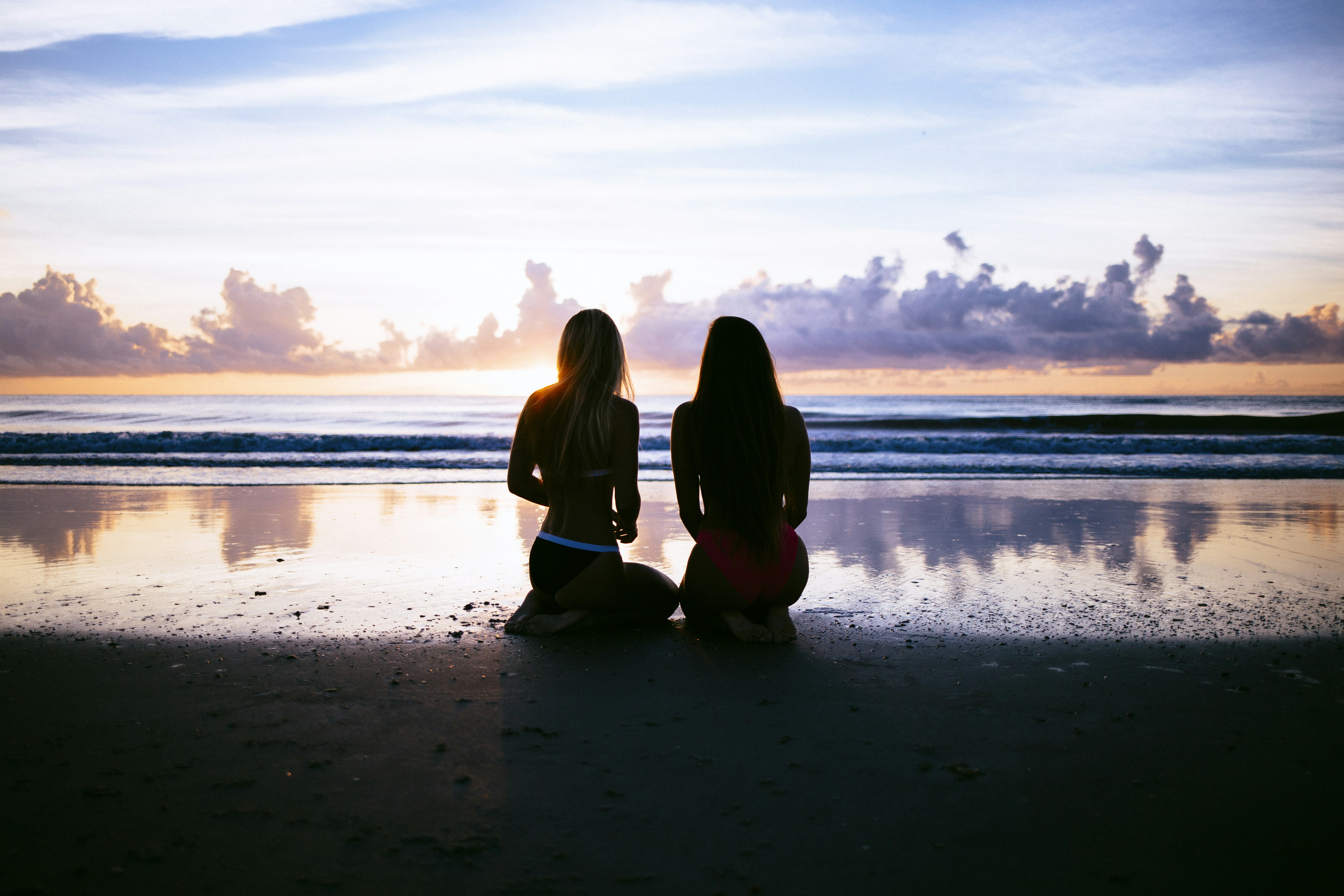 Watching the sunset on wet sand