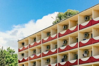 Professional installing a new split AC unit on a bright residential balcony.