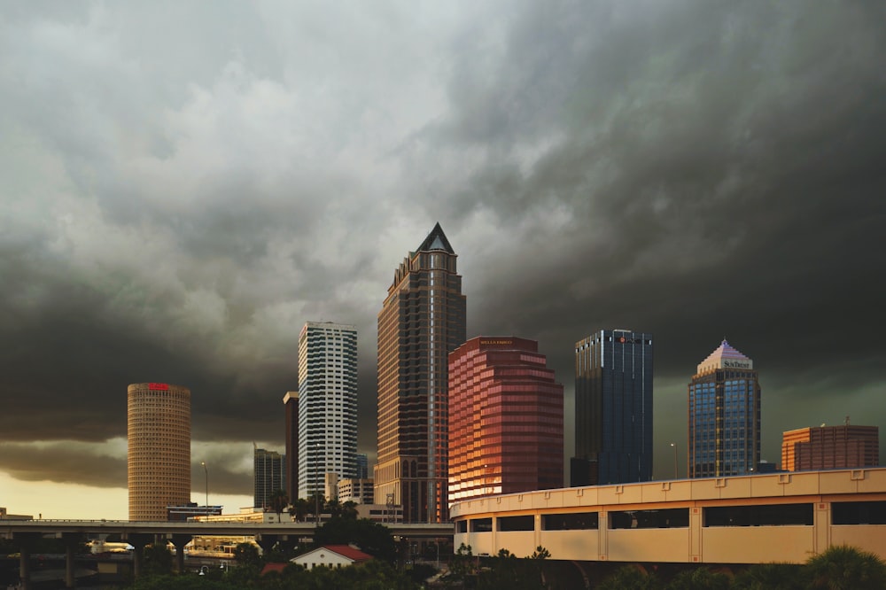 wide angle photo of buildings under cumulus clouds