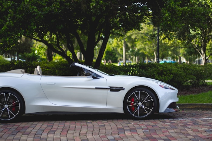 A modern sports car parked outside Apex shop, ready for service