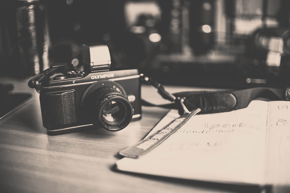 black and silver camera on white paper