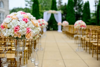 selective focus photography white and pink isle flower arrangement ceremony zoom background