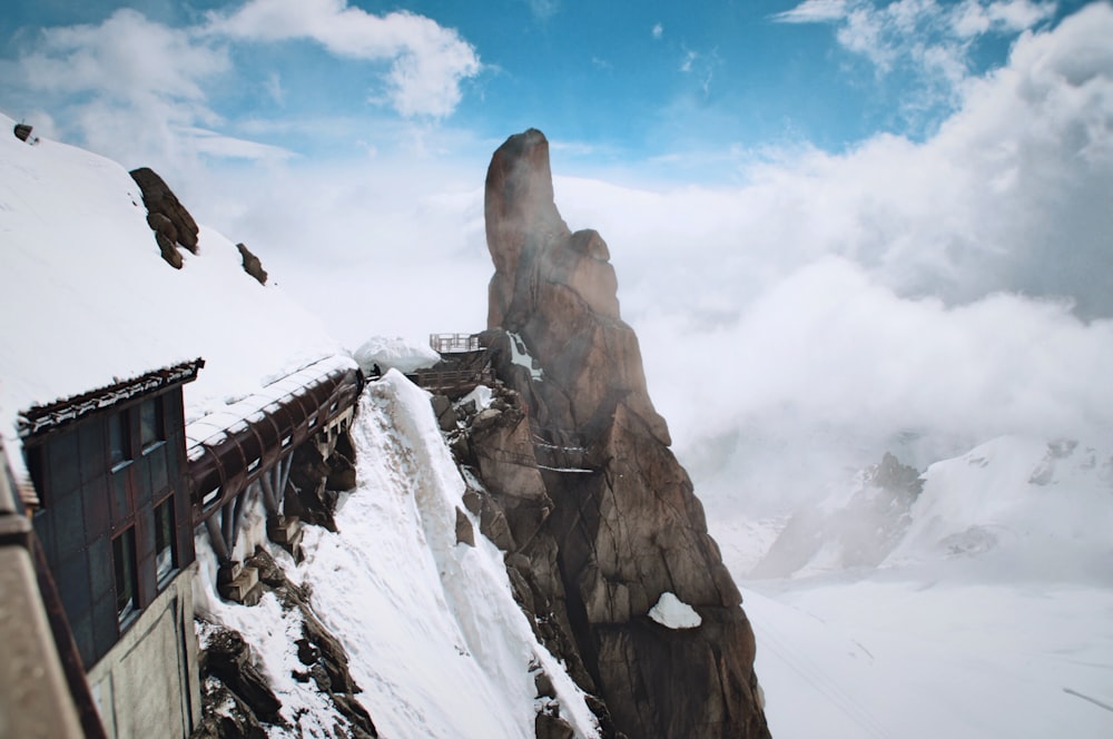 snow filled mountain with train railway