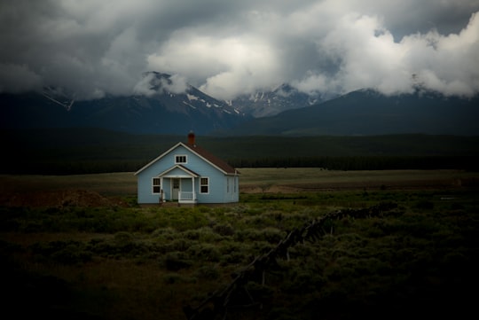 house on grass field under gray sky in Leadville United States