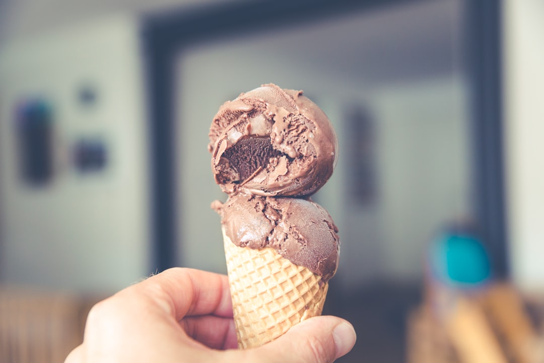 selective focus photography of chocolate ice cream on brown cone