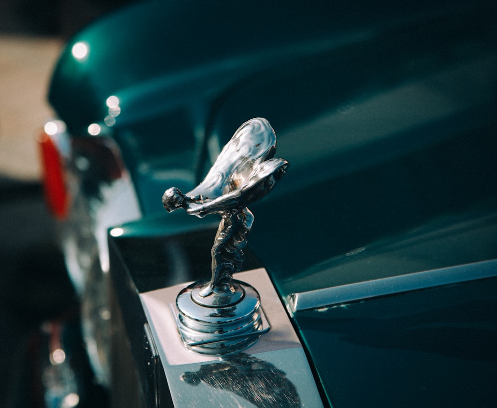 silver-colored vehicle ornament