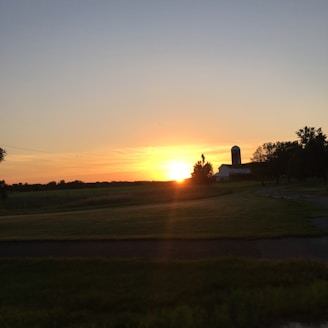Sunset view over the rolling fields and cabins at Star Farms adventure retreat.