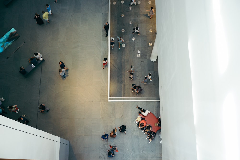 top-view photography of people beside white concrete building