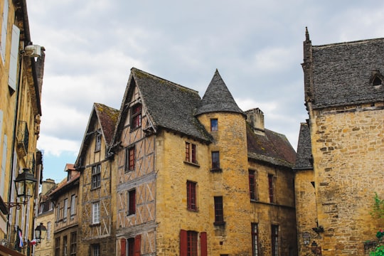 beige concrete houses under blue skies in Sarlat-la-Canéda France