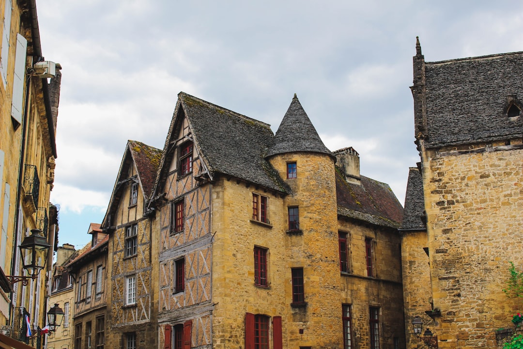 beige concrete houses under blue skies, Old buildings with windows