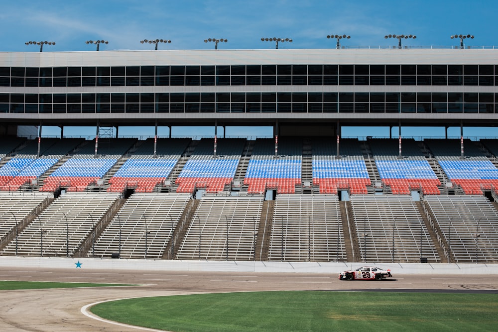 aerial photography of car on stadium under clear blue sky