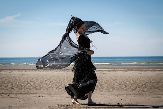 woman dancing on seashore in De Panne Belgium