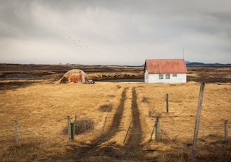 white concrete house during cloudy day photo