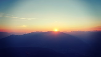 A serene sunset over a mountain range, symbolizing exploration.