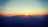 A serene sunset behind a mountain range symbolizing new beginnings.