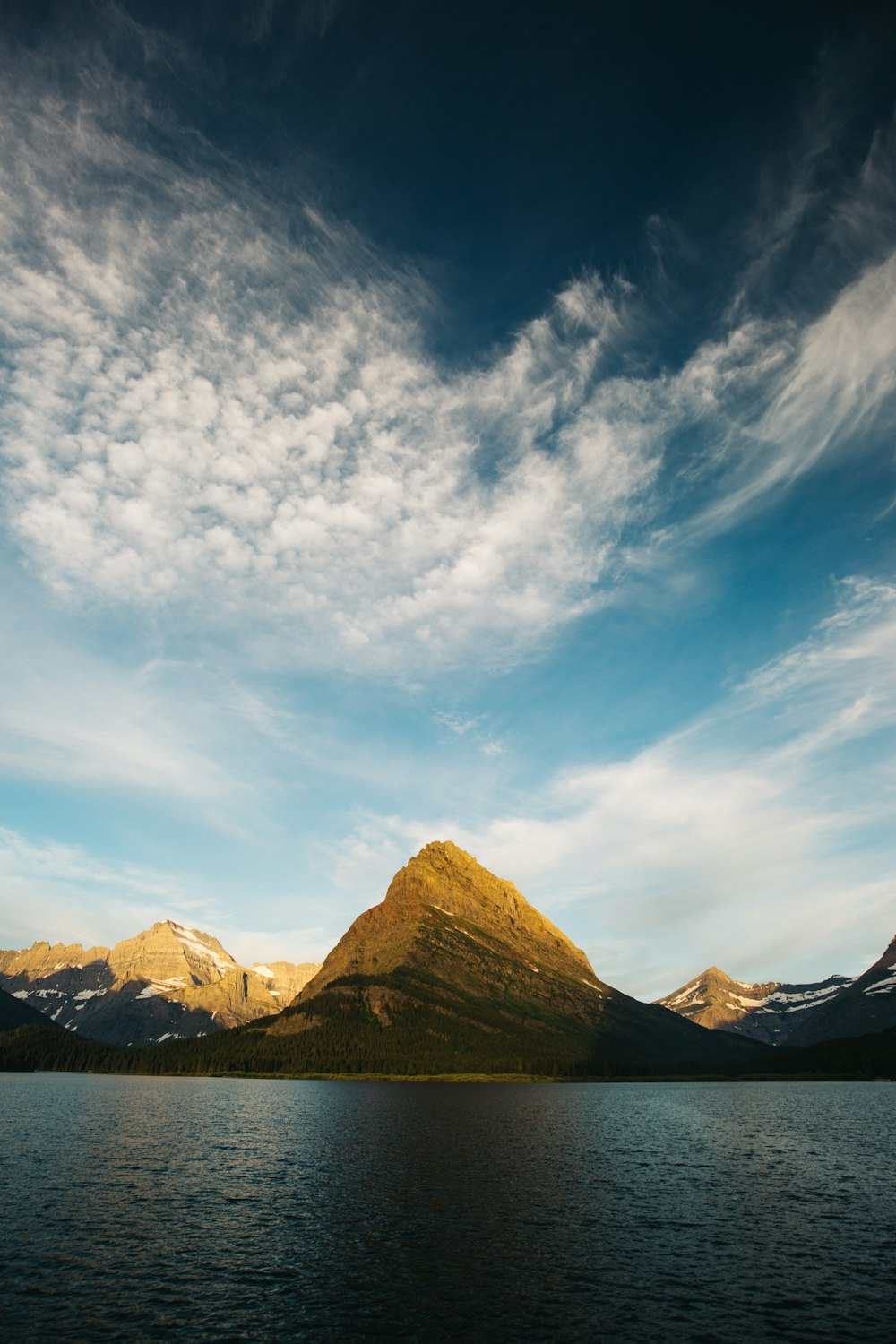 landscape photography of mountains beside body of water