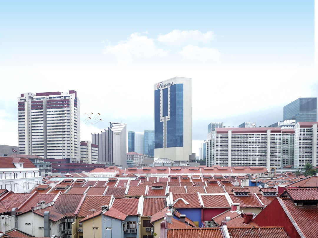 top view of house roofs and high-rise buildings under white sky