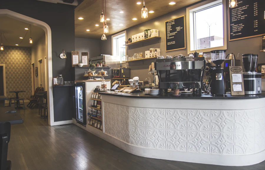 A long curved bar counter in a dark room, espresso machines and a pressed-metal ceiling.