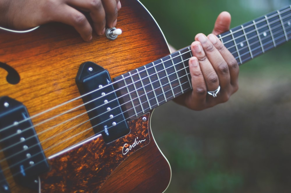 yellow and brown electric guitar