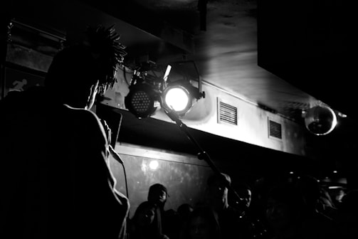 Black and white photo of Sheridan performing on stage.