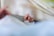 Close-up of a baby’s tiny hand clutching the edge of a gentle, patterned swaddle.