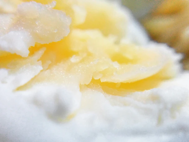 Close-up of the ultra-whipped shea chantilly texture in a creamy beige tone, highlighting its light and airy consistency.