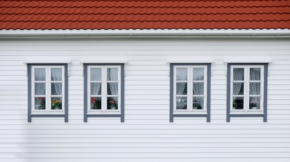 closed white and red house windows