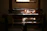 Warm sunlight falling on a craftsman's hands weaving natural fibers in a cozy workshop.