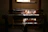 Warm sunlight illuminating a craftsman's hands weaving natural fibers in a cozy workshop.
