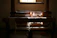 Warm sunlight illuminating a craftsman's hands weaving natural fibers in a cozy workshop.