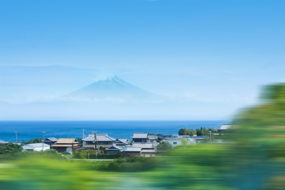 timelapse photo of house near ocean across Mt. Fuji