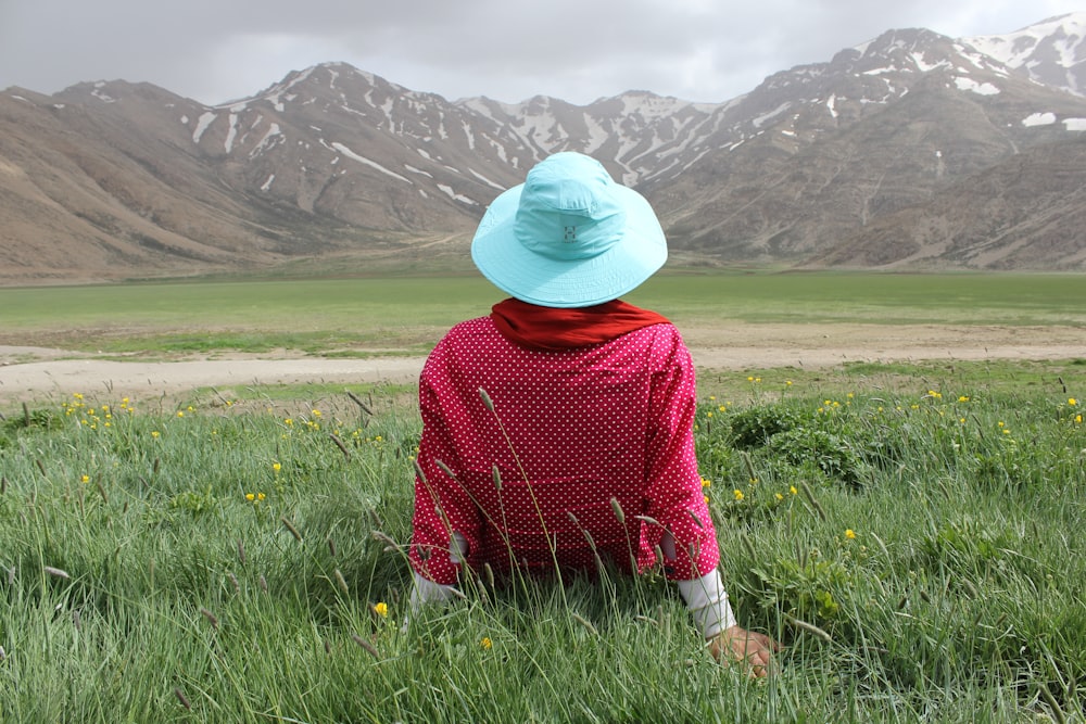 person sitting in green grass lawn