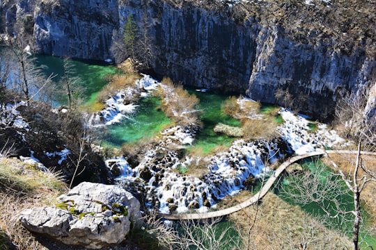 aerial photo of bridge near rock formation in Plitvice Lakes National Park Croatia