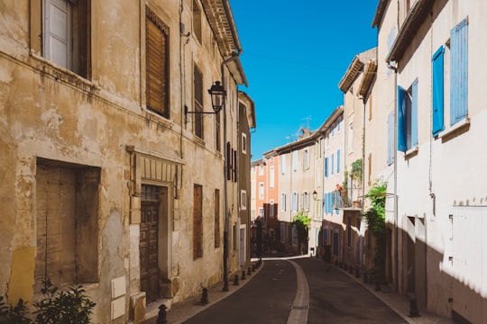 grey concrete road between high-rise buildings during daytime in Saint-Saturnin-lès-Apt France