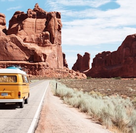 yellow Volkswagen van on road