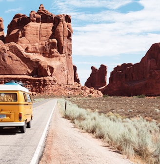 yellow Volkswagen van on road