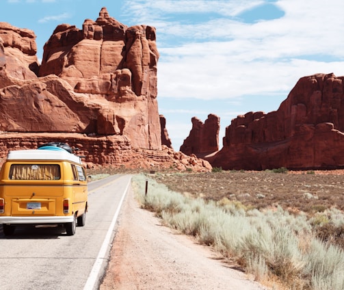 yellow Volkswagen van on road