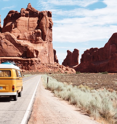 yellow Volkswagen van on road