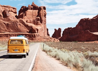 yellow Volkswagen van on road