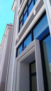 Renovated modern building exterior with fresh paint and new windows.