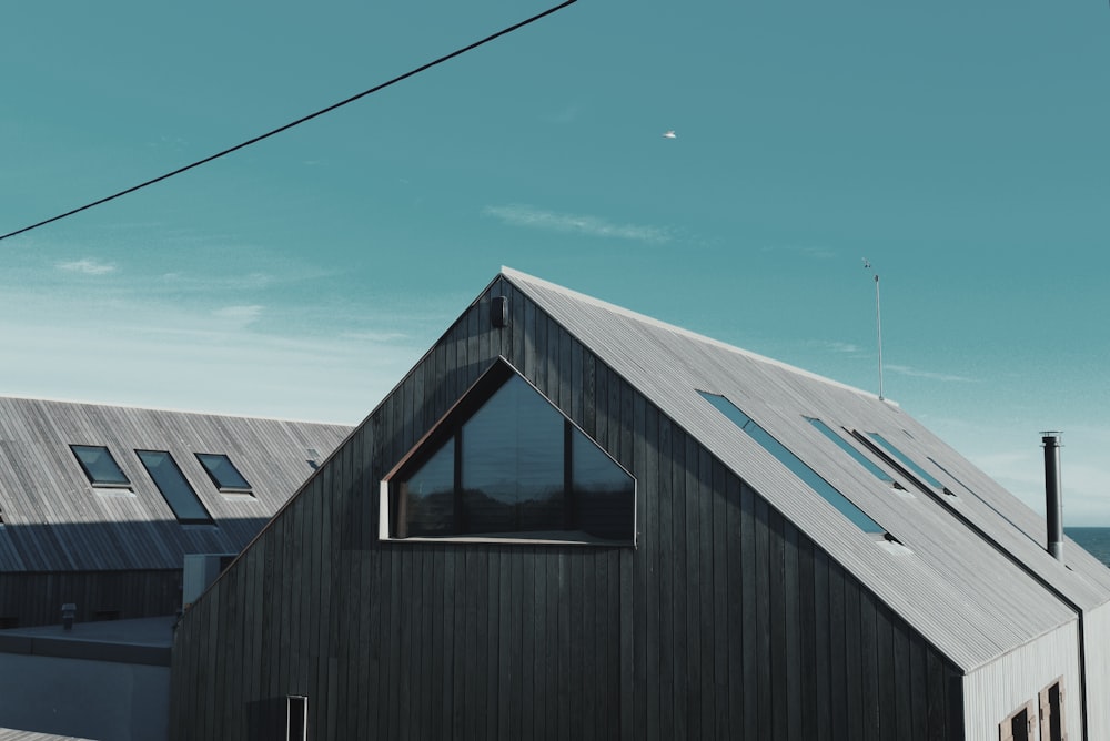 gray wooden house near body of water