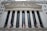 The image features the facade of a grand building with Corinthian columns and a pediment adorned with sculptures. The building is identified as the New York Stock Exchange, with its name prominently displayed. American flags are visible in front of the structure, adding to its formal and historic appearance.