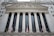 The image features the facade of a grand building with Corinthian columns and a pediment adorned with sculptures. The building is identified as the New York Stock Exchange, with its name prominently displayed. American flags are visible in front of the structure, adding to its formal and historic appearance.