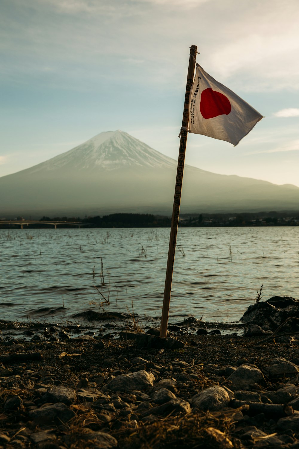 Japan flag mounted near on body of water