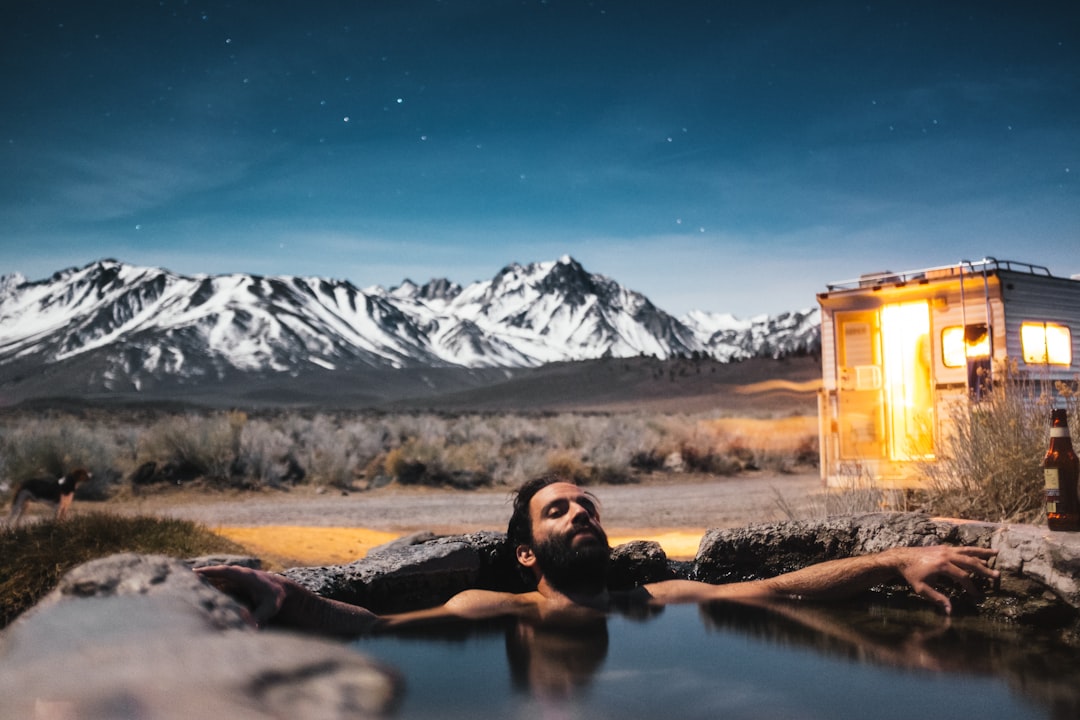 man swimming in spring, Hot stone bath in the mountains