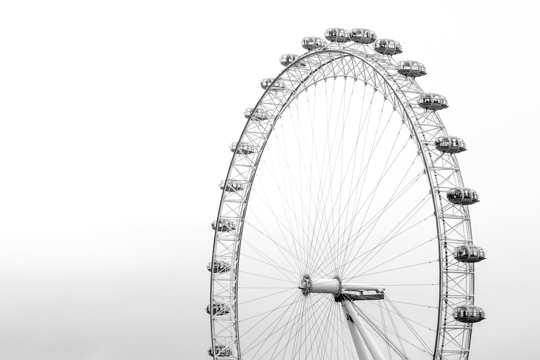 photo of London Eye Ferris wheel near Tower Bridge